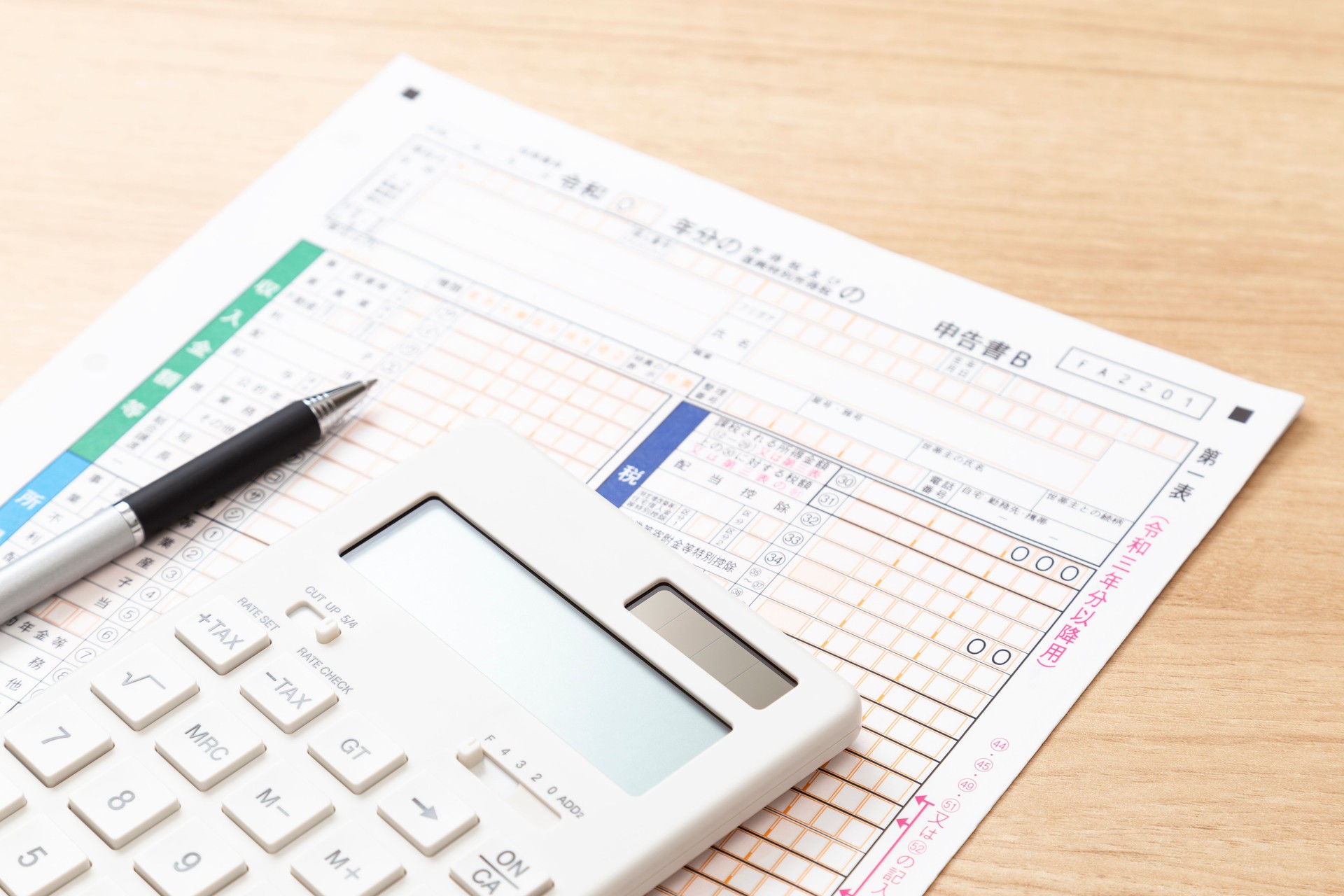 Tax return documents and a calculator on a desk.